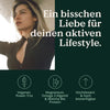 Werbebild mit einer nach oben schauenden Frau, mit deutschem Text und Symbolen, die das Vegan-und-Fit-Set von Nature Love hervorheben.