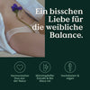 Bild mit einer Nahaufnahme eines Frauenschenkels mit einer lila Blume, gepaart mit einem deutschen Text über das Frauenbalance-Set von Nature Love.
