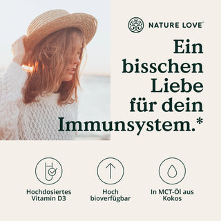 Eine Frau mit Hut und einer Liebe zur Natur, die Sonne genießt, nimmt Vitamin D3 5000 I.E. von Nature Love. Tropfen fällt.