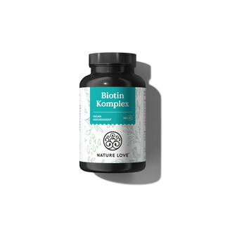 Eine Flasche Biotinkomplex auf schwarzem Hintergrund.